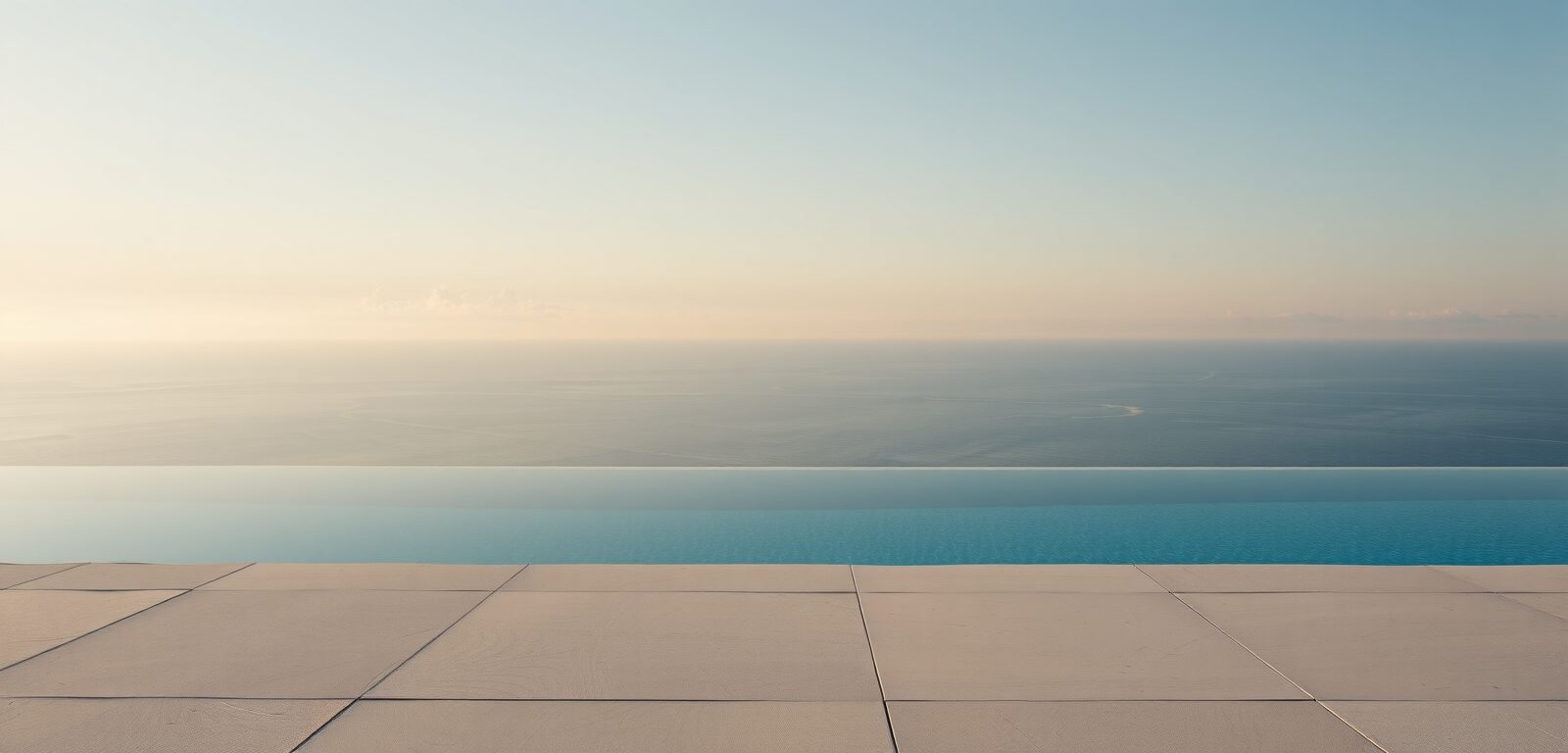 A serene infinity pool above the clouds at dawn, in soft morning light